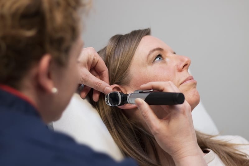 checking ear of client